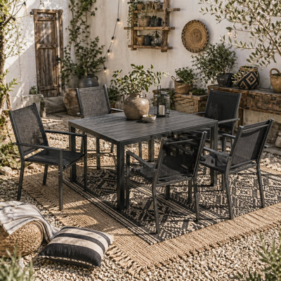 Wyld Haus Nohafa 7-Piece Outdoor Dining Set6 Stackable Black Mesh Chairs With 150 X 90 Cm Rectangular Table from B&Q