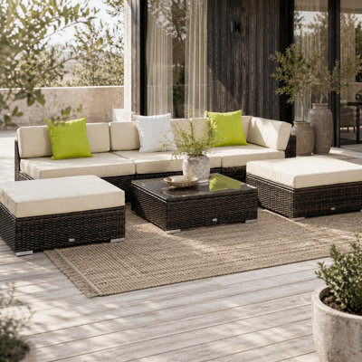 Wyld Haus Baka Brown 9-Seater Modular Rattan Outdoor Sofa And Tempered Glass Coffee Table Set With Cream Cushions from B&Q