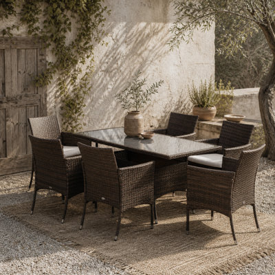 Wyld Haus Dine Rattan 7-Piece Outdoor Dining SetRectangular Tempered Glass Table With 6 Cushioned Armchairs from B&Q