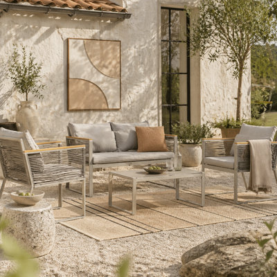 Wyld Haus Rotoyo Kaha Grey 4-Seater Rattan-Style Outdoor Sofa Set With Cushions And Tempered Glass Coffee Table from B&Q