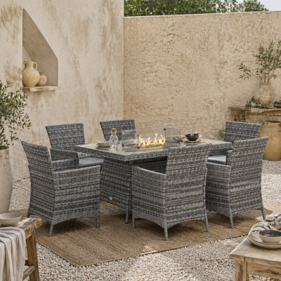 Wyld Haus Ravezi Rattan Grey 6-Seater Garden Dining Set With Central Fire Pit Table And Glass Windscreen from B&Q