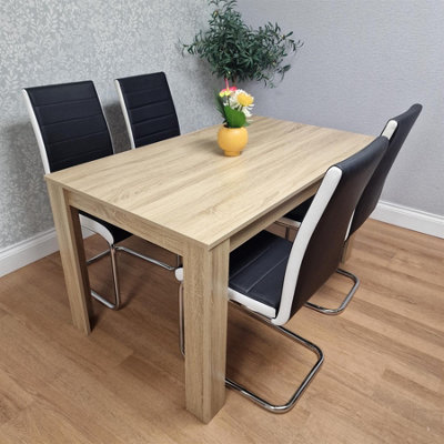 Kosy Koala Oak Effect Table With 4 Black Faux Leather Chairs Dining Furniture from B&Q