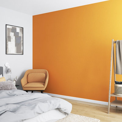 A white bedroom with a bold yellow feature wall and a statement yellow armchair in the corner of the bedroom.