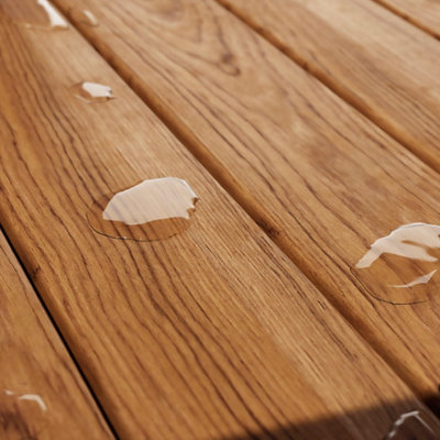Light brown wood decking with repelled water drops