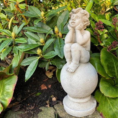 Adorable Stone Cast Boy On Ball Statue from B&Q