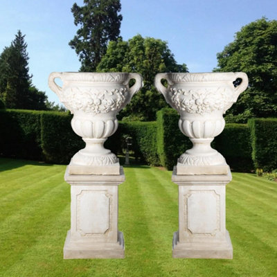  - Pair Of Giant Fruit Design Stone Vases On Plinths