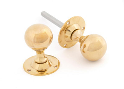 From The Anvil Polished Brass Ball Mortice Knob Set from B&Q
