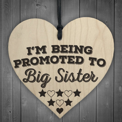 Red Ocean Being Promoted To Big Sister Wooden Hanging Heart Plaque from B&Q