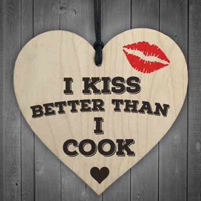 Red Ocean I Kiss Better Than I Cook Novelty Wooden Hanging Heart from B&Q