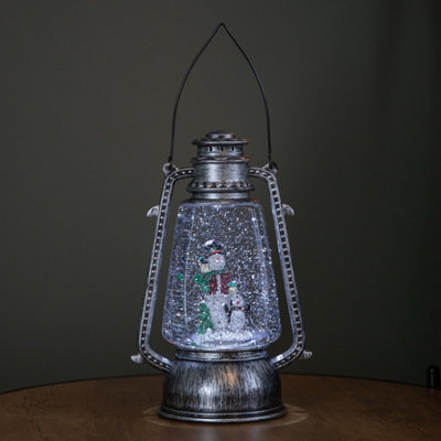 Samuel Alexander 24Cm Dual Powered Light Up Silver Antique Lantern Christmas Water Spinner With Snowman Scene from B&Q
