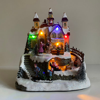 Selections Christmas Village Toy Shop Scene Ornament With Lights Moving Santa Sleigh And Sound from B&Q