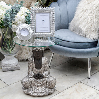 Madison & Mayfair Silver Sitting Buddha Side Table With A Clear Glass Top from B&Q