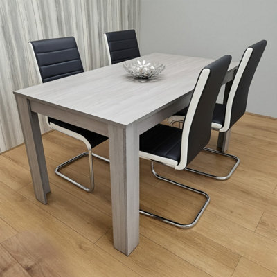 Kosy Koala Modern Grey Dining Table With 4 Black Faux Leather Chairs Dining Furniture Set from B&Q