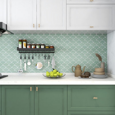 Green fish scale effect tiled kitchen splashback.