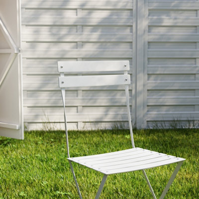 Garden setting with fencing and metal chair painted white