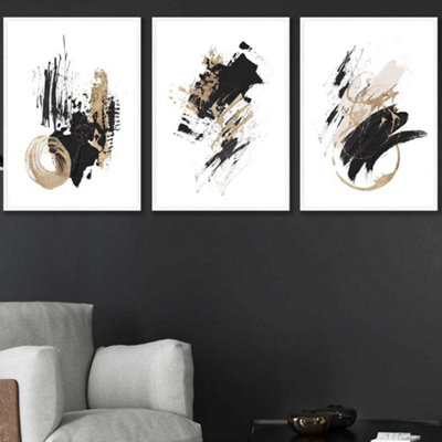 Artze Wall Art Set Of 3  Abstract Black Ivory And Gold Oil Strokes Wall Art Prints / 50X70Cm / White Frame from B&Q