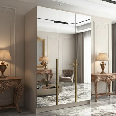 Calia Iii 150Cm Three Door Wardrobe Modern Mirror Front With Contoured Profile Shelves Hanging Rail Cashmere Gold from B&Q