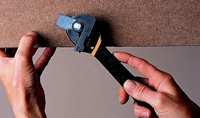 Using an adjustable spanner to secure a ladder release catch.