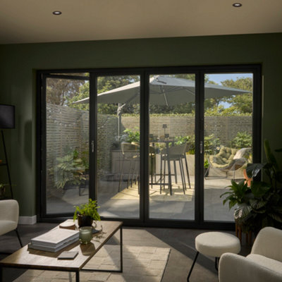 Modern living room looking out to 4 section patio doors with a small garden behind