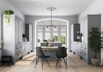 A large light grey kitchen with light wooden floorboards.