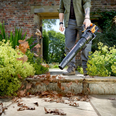 Clearing garden debris with a leaf blower