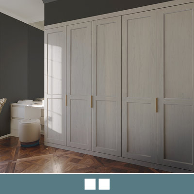 A fitted wardrobe in a two panel shaker style and a textured woodgrain that complements the light porcelain colour finish.