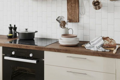 Cream and wooden kitchen with white tiled splashback.