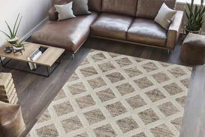 Large rug placed on top of a laminate floor in a living room.