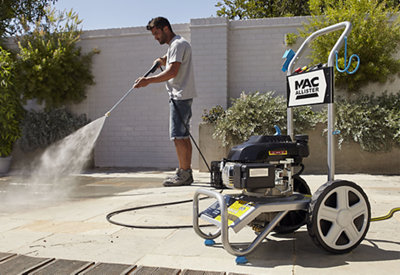 Using a Mac Allister petrol powered pressure washer to clean a patio.