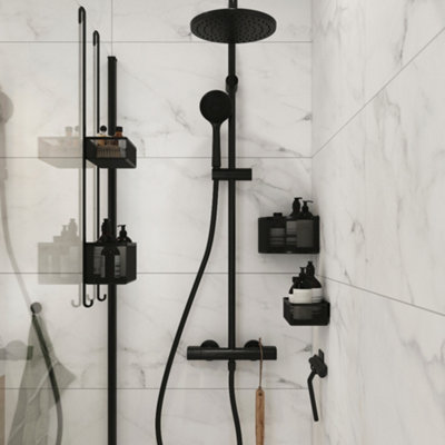 A Shower enclosure with a shower caddy hanging over the door, a corner shower basket, and a wall-mounted toiletry holder.