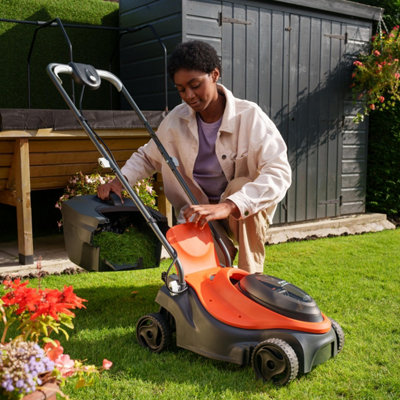 Lawn mower cutting fresh grass
