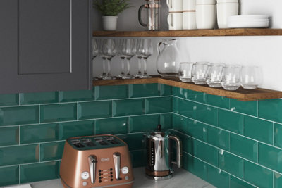 Dark green gloss metro tile kitchen splashback.