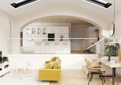 A mezzanine style open plan flat with a large white kitchen on higher floor, and sitting and dining area on the lower floor.