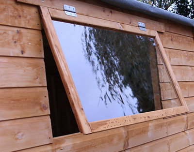 A timber shed with an open window that has top hinges, allowing the window to open outwards.