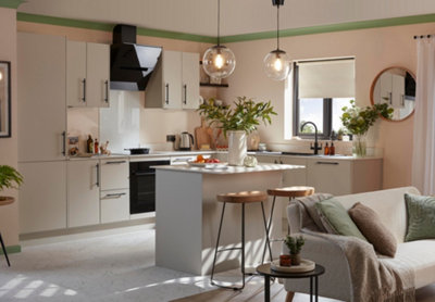 Large grey Scandi kitchen with two large vases of flowers on kitchen worktop.