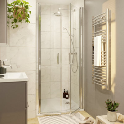 A double shower door installed across a tiled alcove shower enclosure.