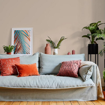 A living room with white sofa and colourful accessories painted in the neutral shade, Valspar Puppy Paws.