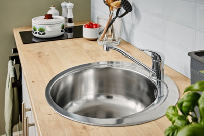 Quimby Inox Stainless steel Circular 1 Bowl Sink installed on top of a wood effect worktop in a bright kitchen space.