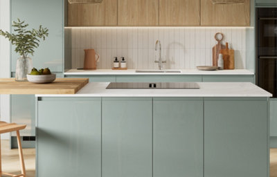 Gloss slab kitchen doors with integrated handles, shown in a light and modern space featuring a white marble-effect worktop and induction hob on an island.