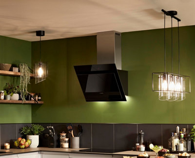 Geometric metal and glass pendant light with a cluster of three shades hanging above a kitchen island, with two matching singular lights in other areas of the kitchen.