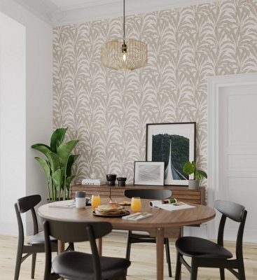 A modern dining room with a soft beige leaf-print wallpaper against a white background, featuring a circular dark brown dining table, black chairs, and houseplants.