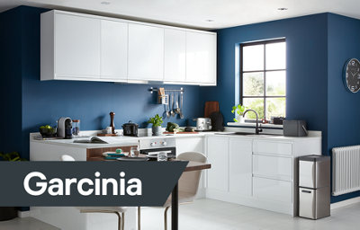 The Garcinia kitchen, featuring glossy white cabinets with integrated handles, and white countertops.
