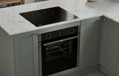The Tydeman kitchen, featuring shaker style cabinets in muted, earthy green.