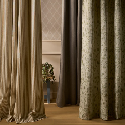 Selection of curtains in different styles and patterns, including striped, plain and botanical designs, displayed in neutral tones.