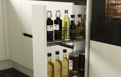 An open gloss slim cabinet showing a selection of bottled oils stored inside.