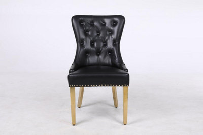 A Pair of Leather Aire Dining Chairs with Golden Legs in Black