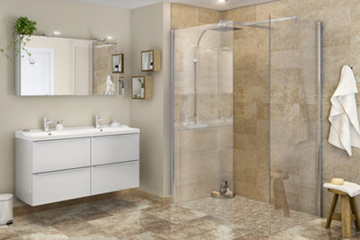 A bright bathroom with beige-painted walls and light beige tiles in the shower enclosure.