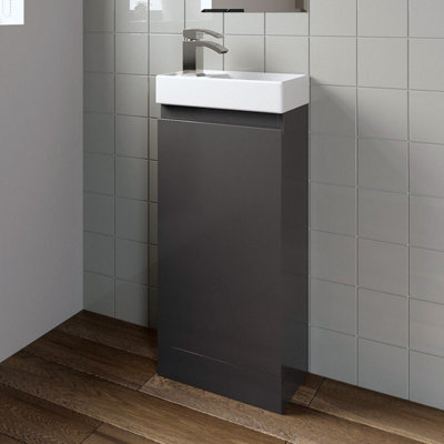 Veleka gloss grey freestanding vanity unit basin set in a green and grey bathroom.