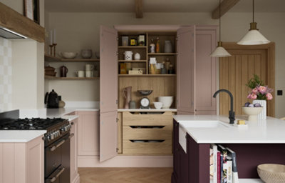 Shaker-style kitchen in antique rose with oak pantry storage, open shelving, white worktops and blackberry kitchen island.