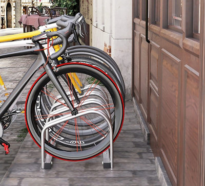 A bicycle locking storage stand with bikes mounted on it.